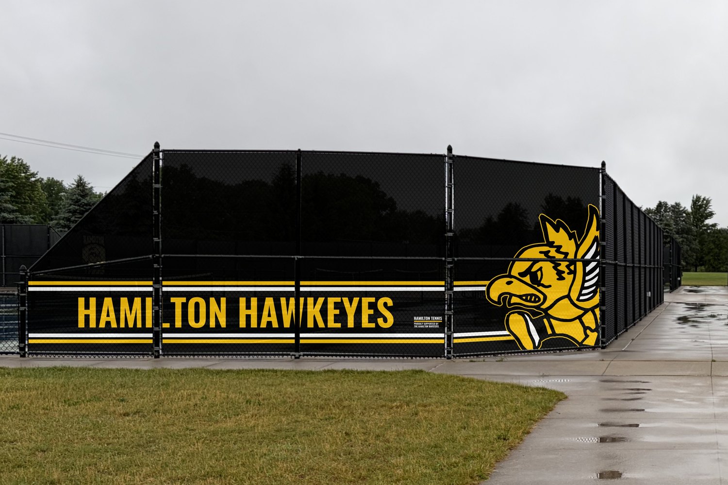 Hamilton Hawkeyes wind screens on the tennis court enclosure